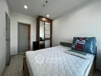 Modern bedroom with sleek wardrobe and comfortable bed in a stylish apartment.