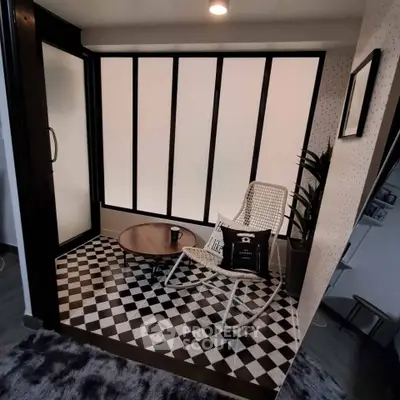 Chic modern balcony with stylish furniture and geometric flooring, perfect for relaxation.