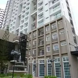 Modern high-rise building exterior with large windows and contemporary design.
