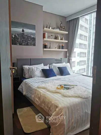 Cozy modern bedroom with stylish decor and city view, perfect for urban living.