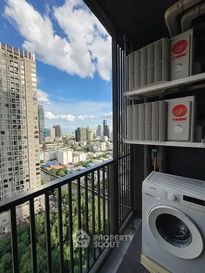 High-rise balcony with city view and washing machine, perfect for urban living.