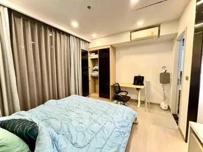 Modern bedroom with cozy decor and ample storage in a stylish apartment.