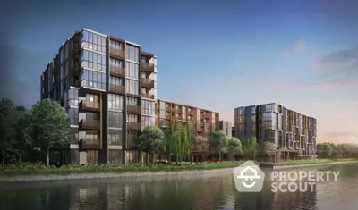 Modern riverside apartment buildings with lush greenery and serene water views.