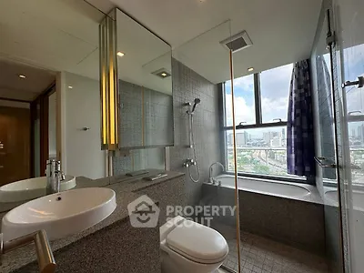 Luxurious bathroom with city view, featuring modern fixtures and a spacious bathtub.