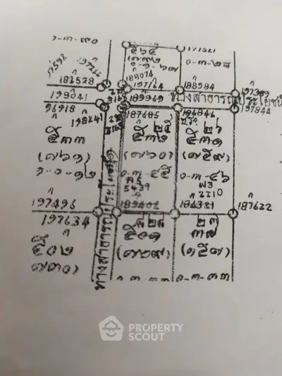 Detailed schematic plan of a property layout with measurements and plot divisions.