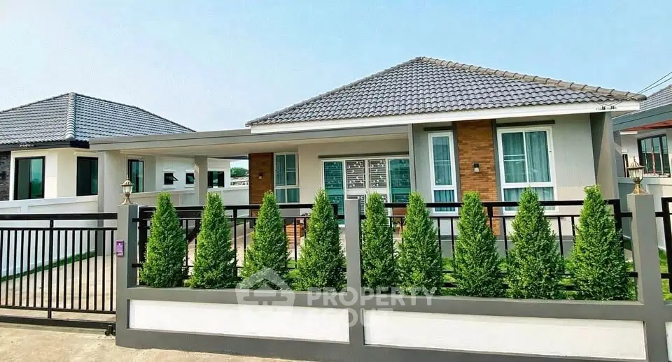 Charming single-story home with modern design and lush greenery in a serene neighborhood.