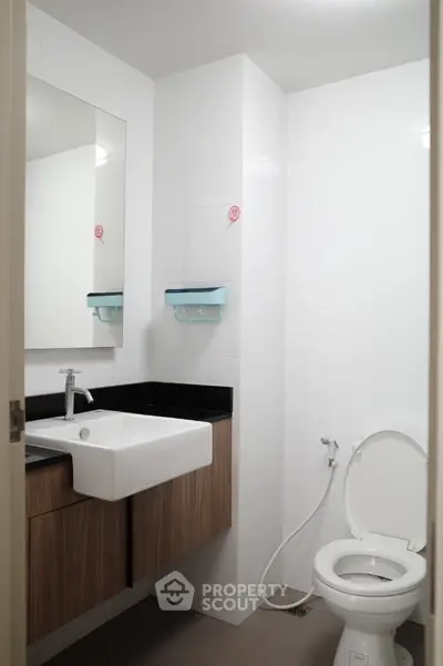 Modern bathroom with sleek sink and toilet in minimalist design