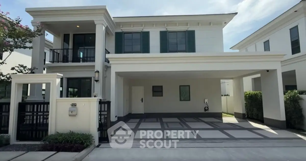 Elegant two-story house with spacious driveway and modern architecture in a serene neighborhood.