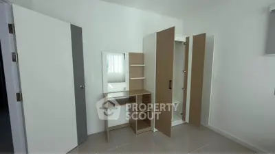 Modern minimalist bedroom with sleek wardrobe and vanity set