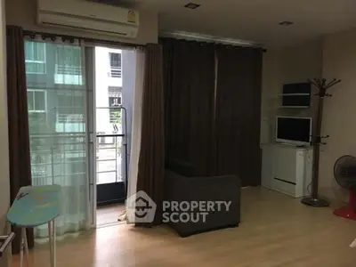 Cozy living room with balcony access in modern apartment