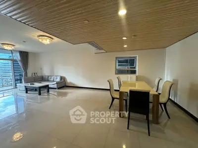 Spacious modern living room with elegant dining area and large windows for natural light.