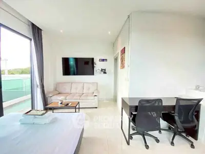Modern studio apartment with balcony, featuring a cozy living area and workspace.