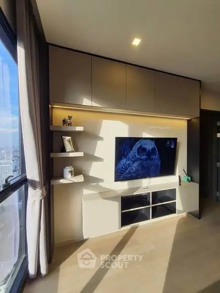 Modern living room with sleek TV unit and large window view