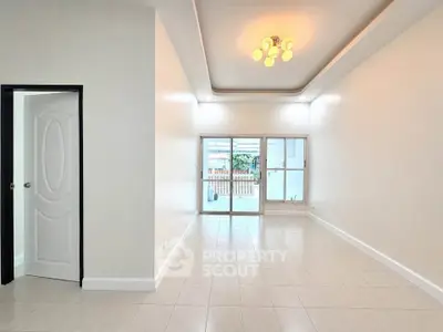 Spacious living room with elegant lighting and large windows for natural light.
