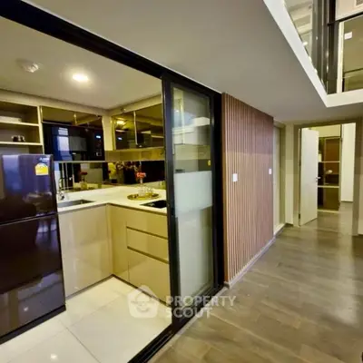 Modern kitchen with sleek cabinetry and open layout in stylish apartment