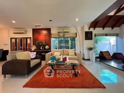 Spacious living room with modern decor and large windows in a stylish home.