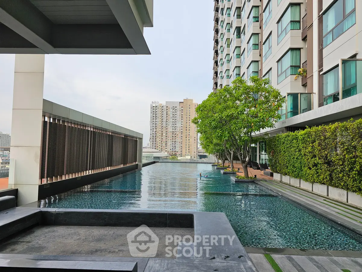 Luxurious high-rise building with stunning pool and city view, perfect for modern urban living.