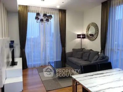 Modern living room with stylish decor and large windows for natural light.