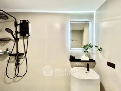 Modern bathroom with sleek fixtures and illuminated mirror