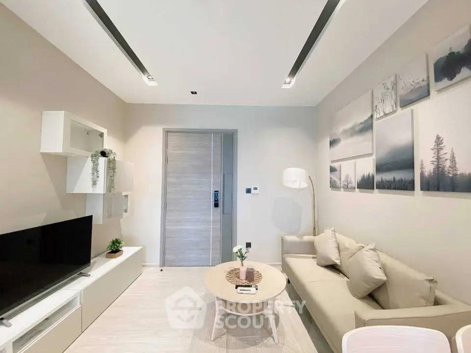 Modern living room with stylish decor and neutral tones, featuring a cozy sofa and sleek entertainment unit.