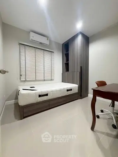 Modern bedroom with sleek furniture and air conditioning, perfect for comfort and style.