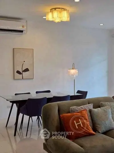 Modern living room with stylish furniture and elegant lighting, perfect for a cozy and inviting atmosphere.