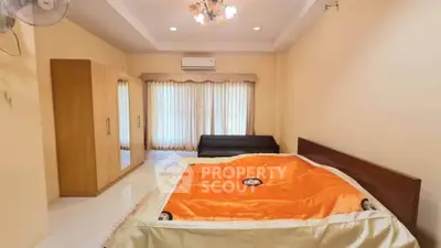 Spacious bedroom with modern furnishings and natural light