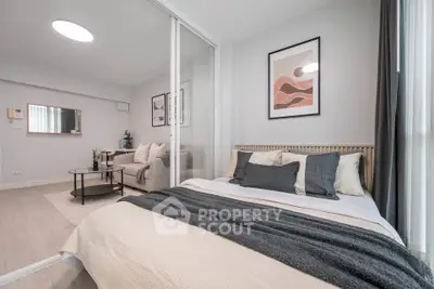 Modern bedroom with stylish decor and cozy living area in open layout apartment.
