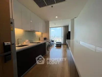 Modern kitchen with open layout and city view, featuring sleek appliances and wooden flooring.