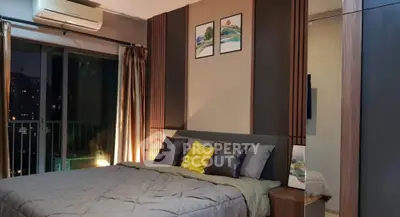 Luxurious bedroom with modern decor and balcony view in upscale apartment