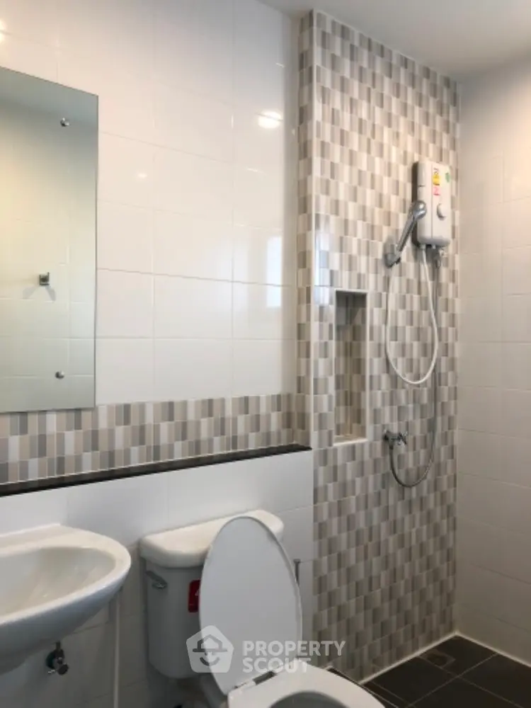 Modern bathroom with stylish tile design and shower unit