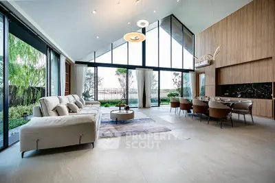 Luxurious open-plan living room with high ceilings and garden view