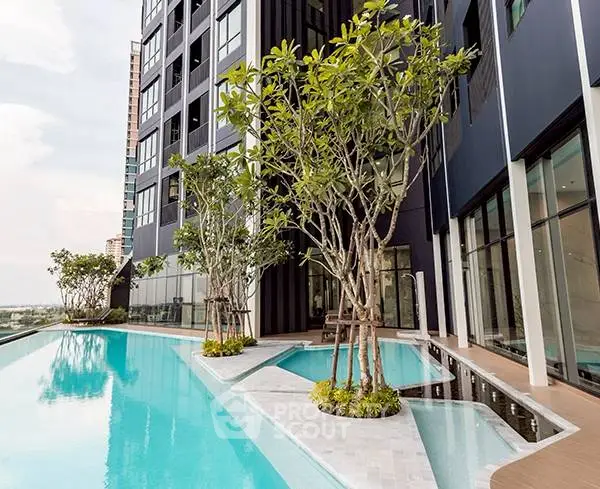 Luxurious modern apartment building with stunning pool and lush greenery