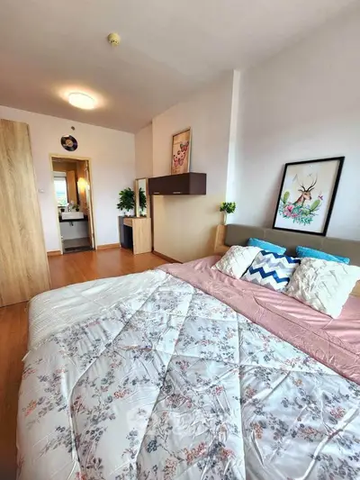 Spacious bedroom with stylish decor and cozy bedding in modern apartment