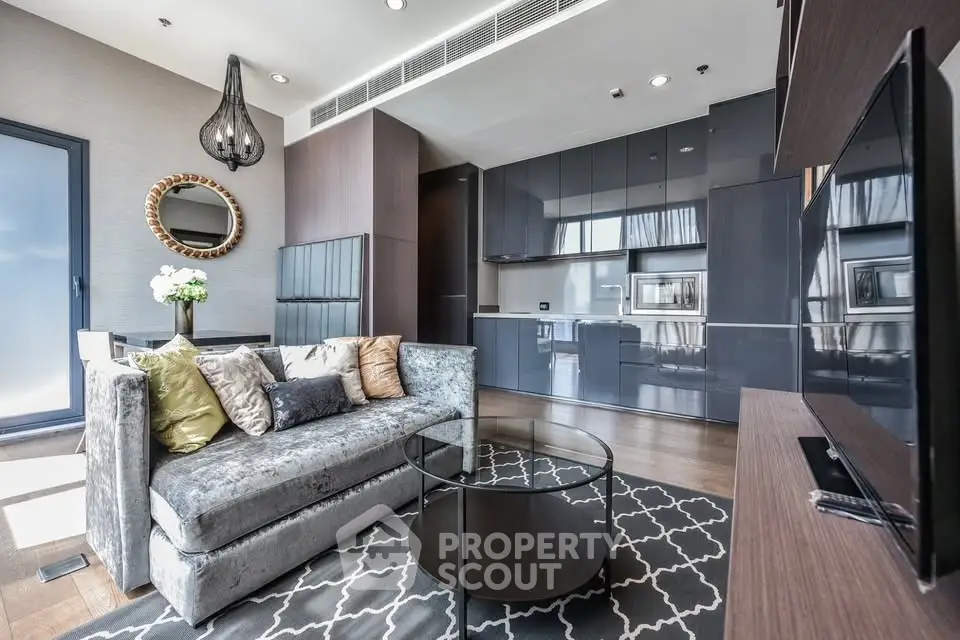 Luxurious modern living room with sleek kitchen, stylish decor, and elegant lighting in a high-end apartment.