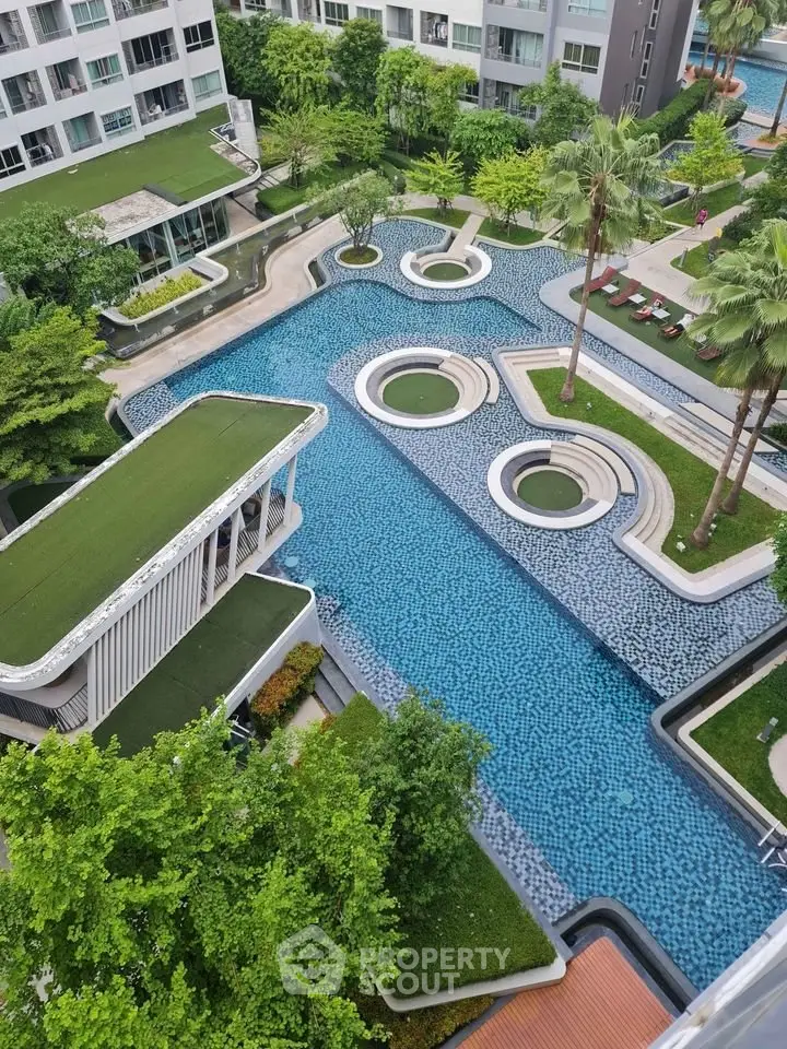 Luxurious modern apartment complex with stunning pool and lush greenery view.