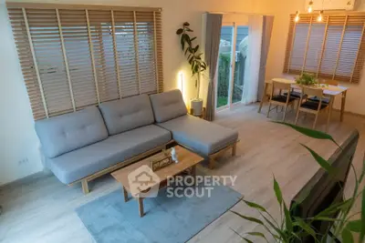 Spacious modern living room with stylish furniture and large windows for natural light.