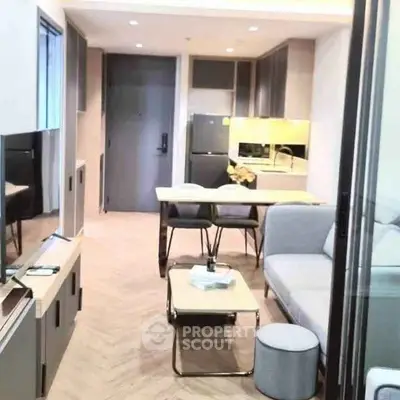 Modern open-layout living room with sleek kitchen and stylish furniture