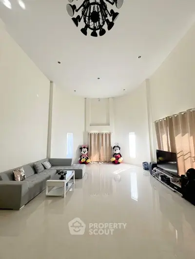 Spacious living room with high ceiling and modern decor