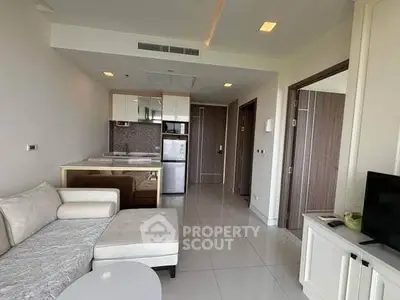 Modern living room with open kitchen and sleek furniture in a stylish apartment.