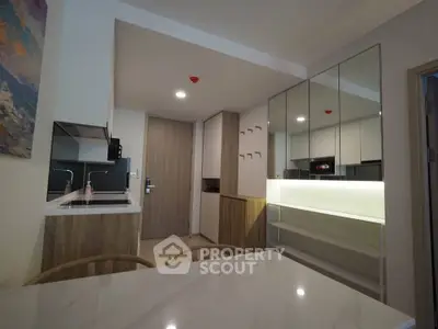 Modern kitchen with sleek cabinetry and integrated appliances in a stylish apartment.