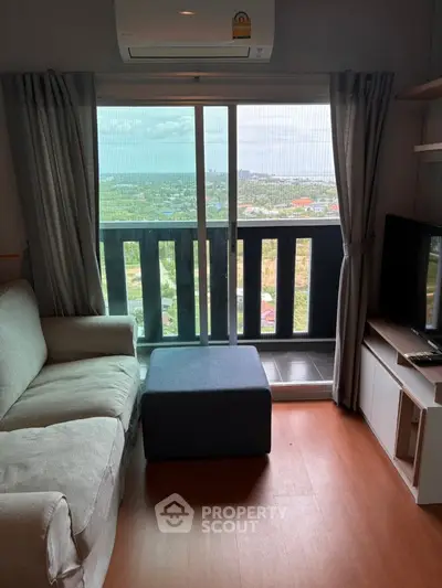 Cozy living room with balcony offering stunning city view