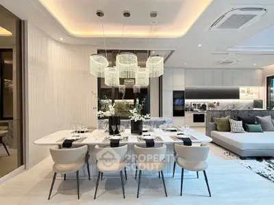 Luxurious modern dining and living area with elegant lighting and stylish decor.