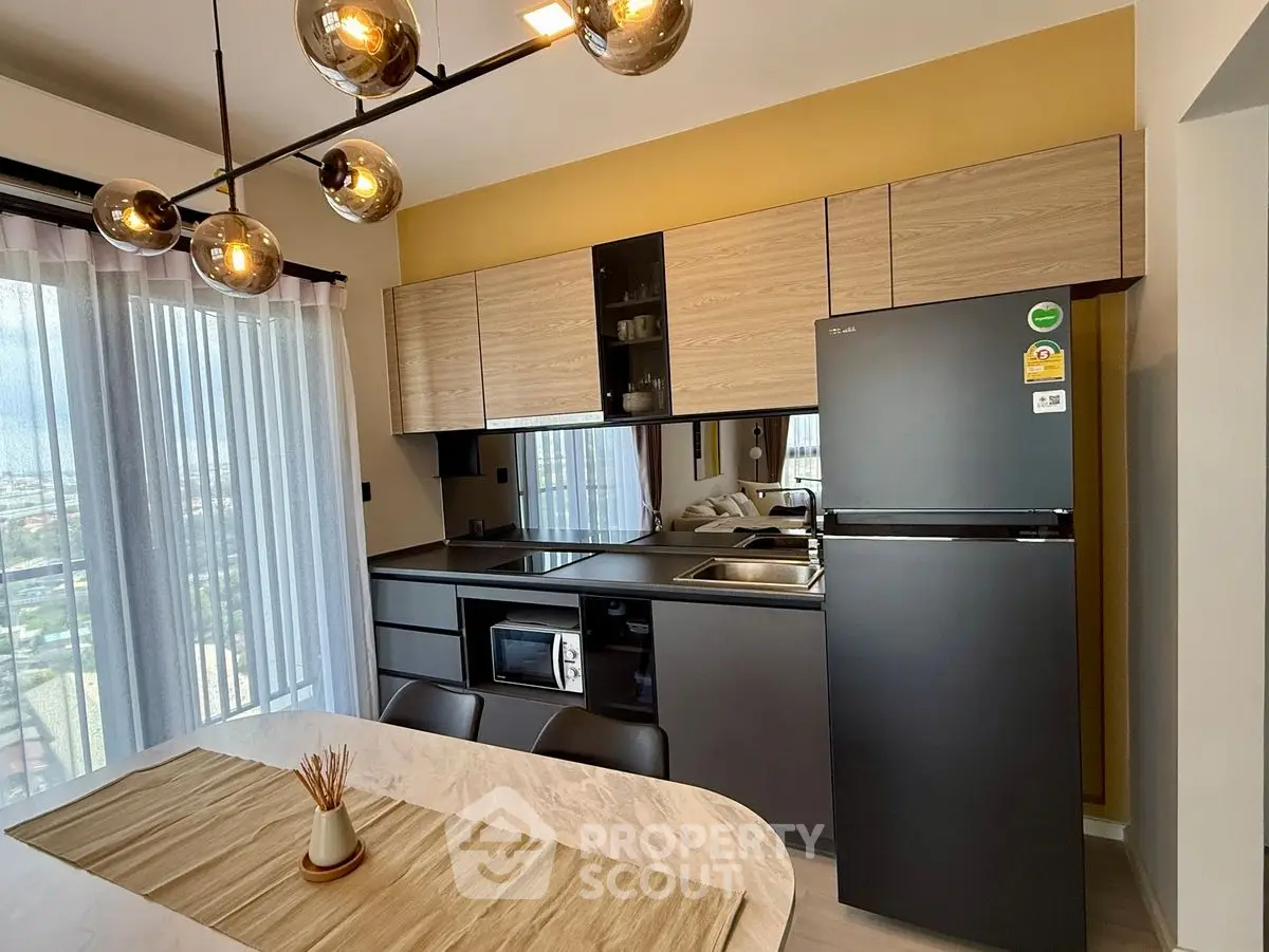 Modern kitchen with sleek appliances and stylish dining area