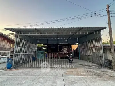 Spacious metal garage with open front and ample parking space
