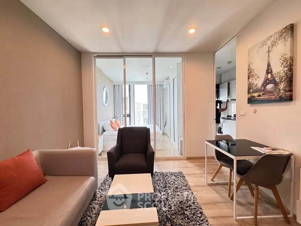 Modern living room with stylish furniture and open layout leading to bedroom, perfect for urban living.