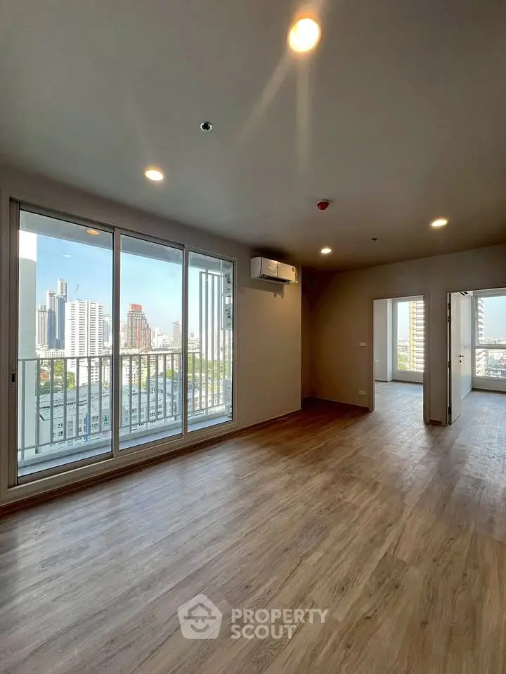 Spacious modern apartment with city view and wooden flooring