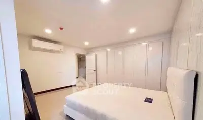 Spacious bedroom with modern design and ample closet space in a luxury apartment.