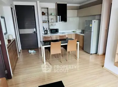 Modern kitchen with dining area featuring sleek cabinetry and stainless steel appliances.