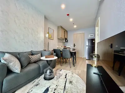 Modern living room with stylish decor and open kitchen layout in a cozy apartment.